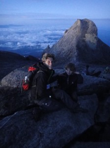 Z and I on top of Mount Kinabalu, with clouds below us and granite peaks behind. Borneo, Malaysia.